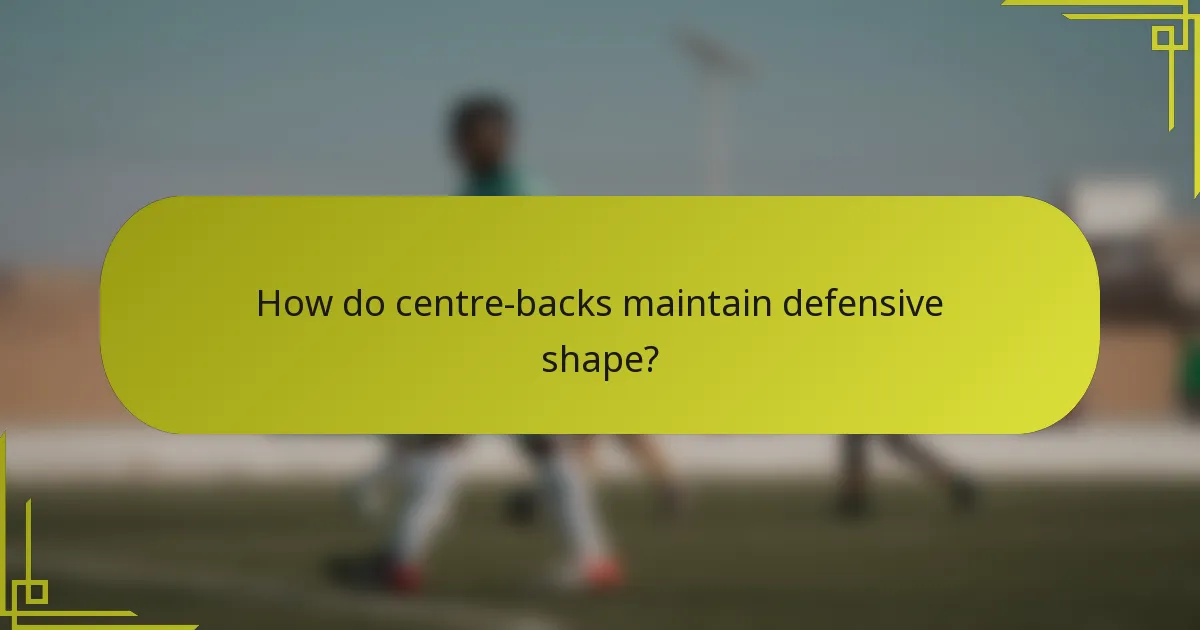 How do centre-backs maintain defensive shape?